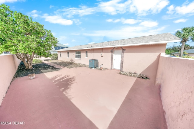 rear view of house featuring central AC and a patio area