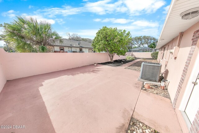110 Ponce Terrace Cir, Ponce Inlet, FL 32127 - view of patio with central AC and a fenced backyard