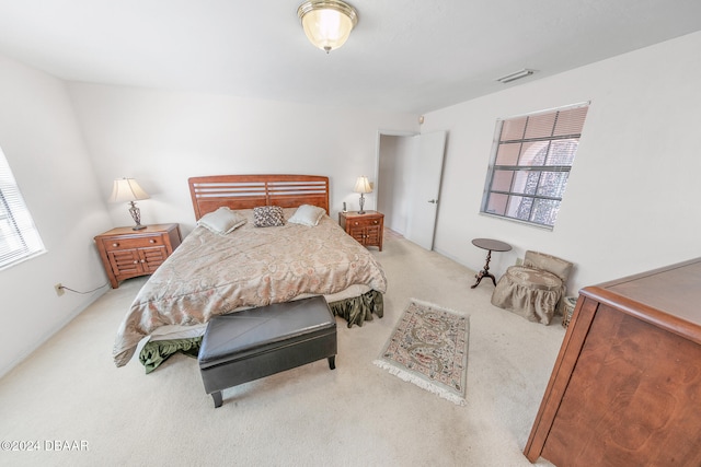 carpeted bedroom with multiple windows