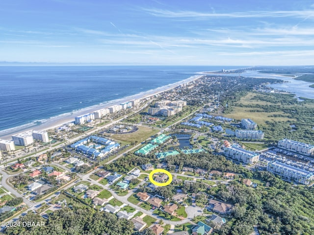 drone / aerial view with a beach view and a water view