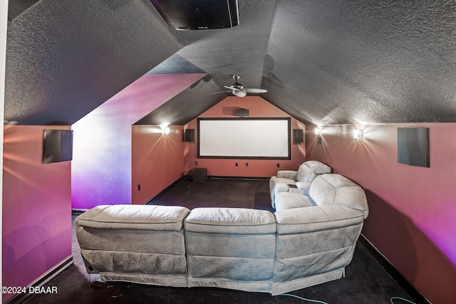 cinema featuring ceiling fan, dark colored carpet, a textured ceiling, and vaulted ceiling