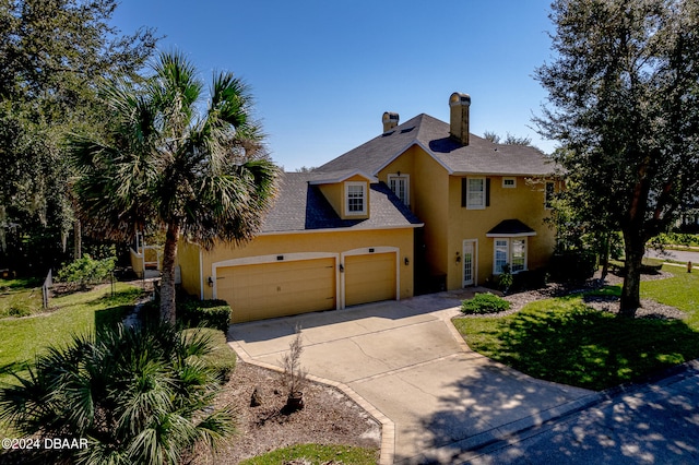 view of front facade with a front lawn and a garage