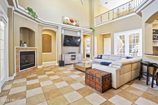 living room featuring a towering ceiling and a fireplace