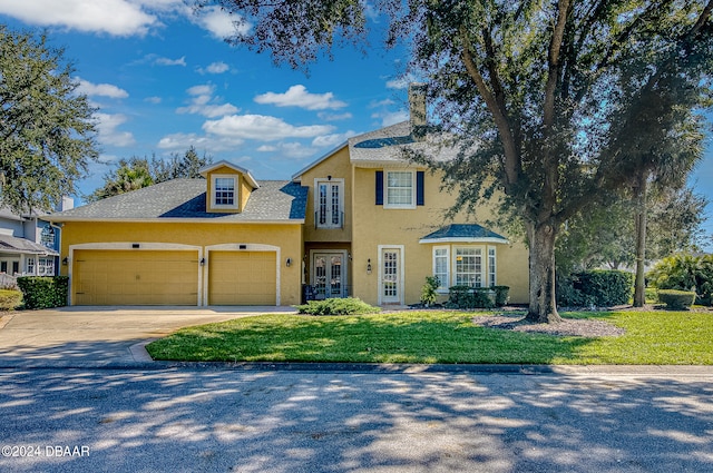 view of front of property with a garage and a front yard