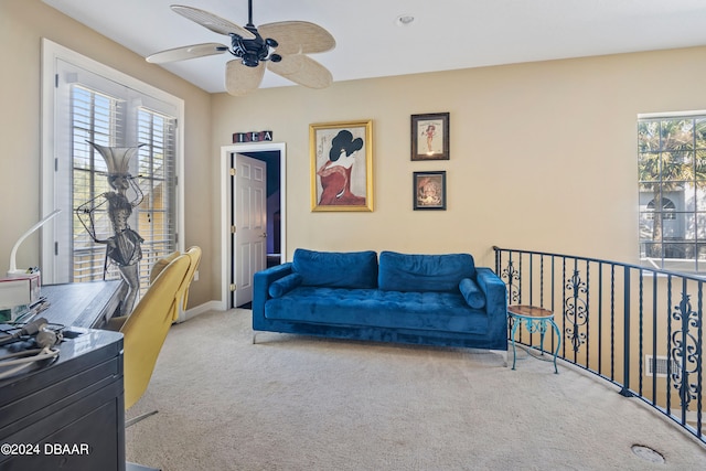 interior space featuring light carpet and ceiling fan