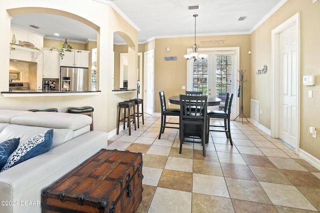 dining space featuring a notable chandelier and crown molding