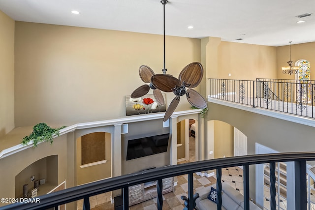 room details with ceiling fan with notable chandelier