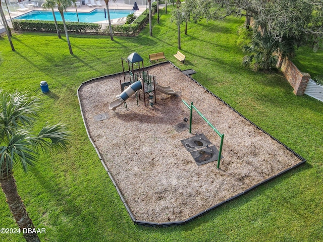 view of property's community with a lawn and a swimming pool