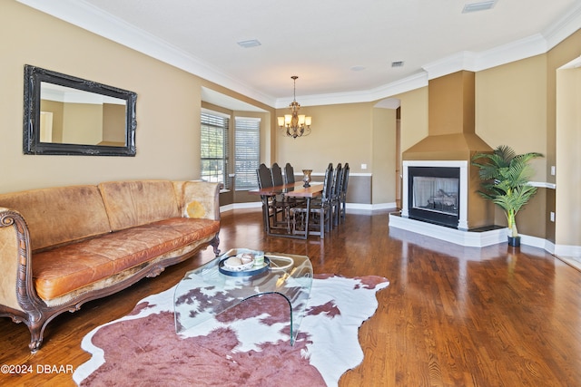 living room featuring a notable chandelier, dark hardwood / wood-style floors, and crown molding