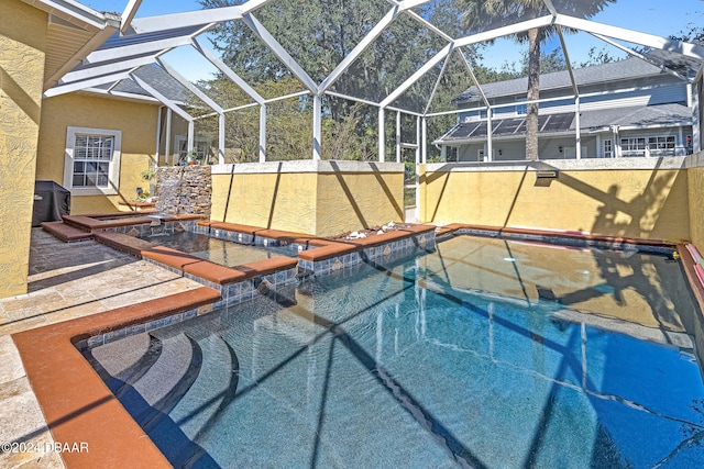 view of swimming pool featuring glass enclosure, a jacuzzi, and a patio