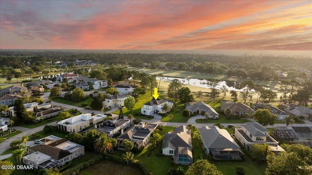 aerial view at dusk with a water view