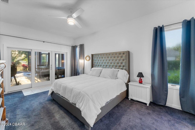 carpeted bedroom featuring access to exterior, radiator heating unit, multiple windows, and ceiling fan