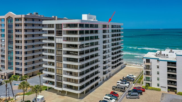 view of property featuring a view of the beach and a water view