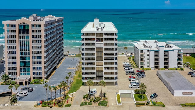 birds eye view of property featuring a beach view and a water view