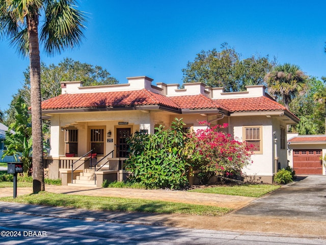 mediterranean / spanish home featuring a porch