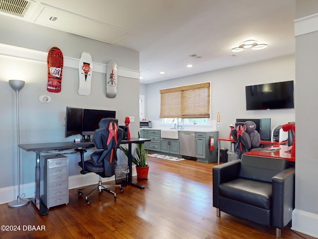 office area with wood-type flooring and sink