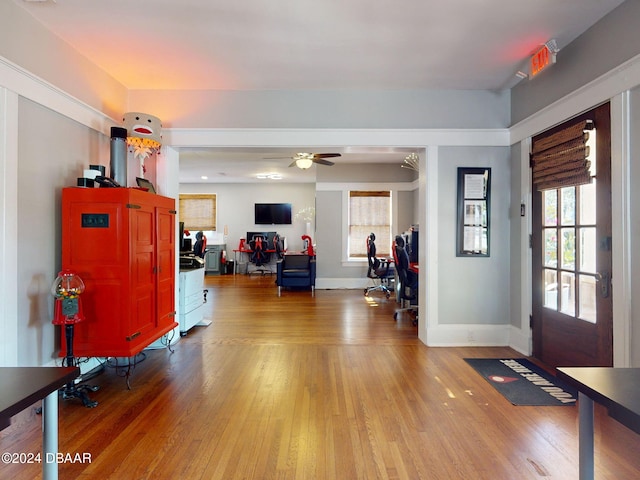 foyer entrance featuring hardwood / wood-style flooring, ceiling fan, and a wealth of natural light