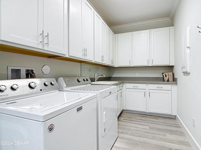 laundry room with separate washer and dryer, cabinets, sink, ornamental molding, and light hardwood / wood-style flooring