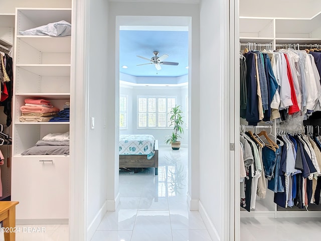 walk in closet featuring ceiling fan