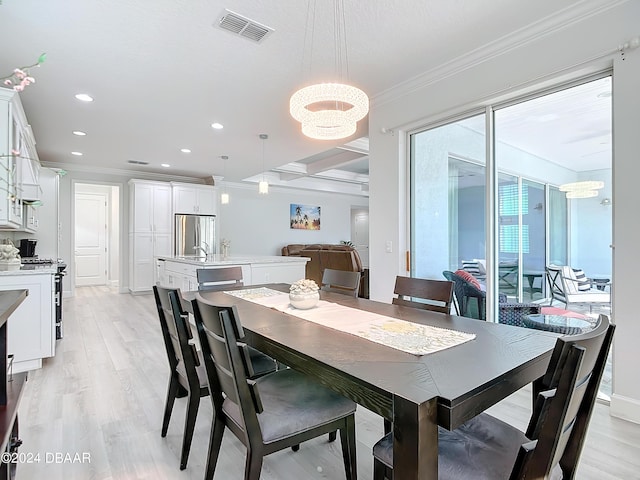 126 Island Breeze Ave, Daytona Beach, FL 32124 - dining area featuring crown molding, light wood-style flooring, recessed lighting, and a chandelier