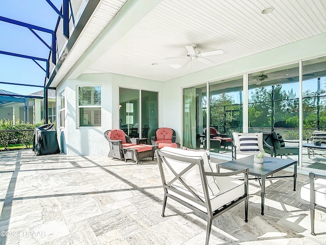 view of patio with an outdoor living space, a lanai, and ceiling fan