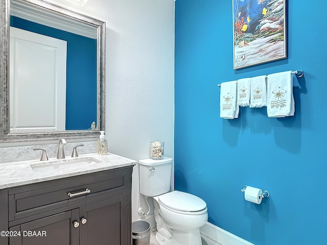 bathroom featuring toilet and vanity