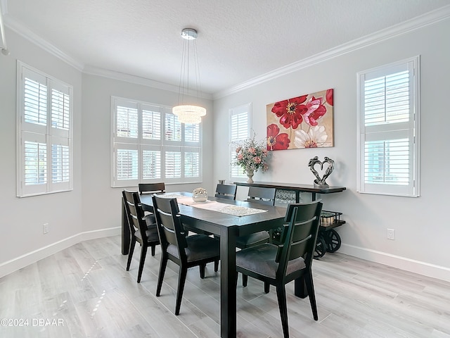 dining area with crown molding and plenty of natural light