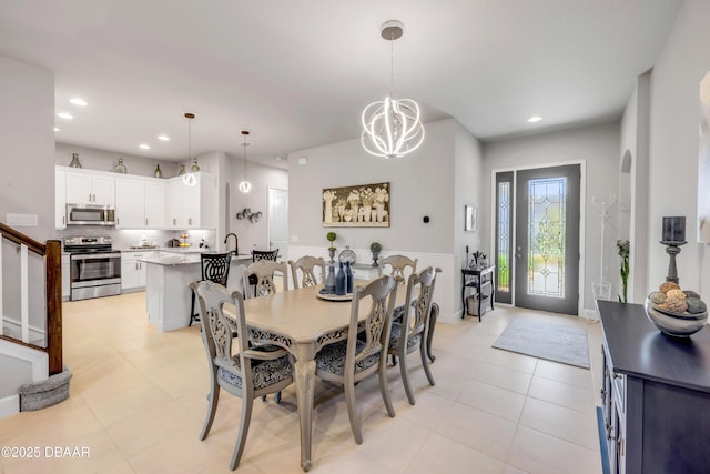 110 Longridge Ln, Ormond Beach, FL 32174 - dining space featuring recessed lighting, a chandelier, light tile patterned floors, and stairs