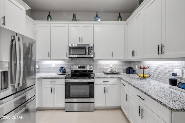 110 Longridge Ln, Ormond Beach, FL 32174 - kitchen featuring stainless steel appliances, white cabinetry, and tasteful backsplash