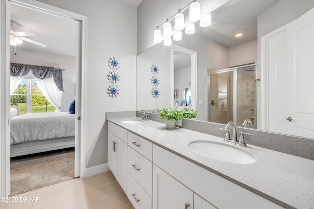 110 Longridge Ln, Ormond Beach, FL 32174 - ensuite bathroom featuring double vanity, ceiling fan, a stall shower, tile patterned floors, and baseboards
