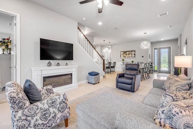110 Longridge Ln, Ormond Beach, FL 32174 - living room featuring stairway, a ceiling fan, tile patterned flooring, recessed lighting, and a glass covered fireplace