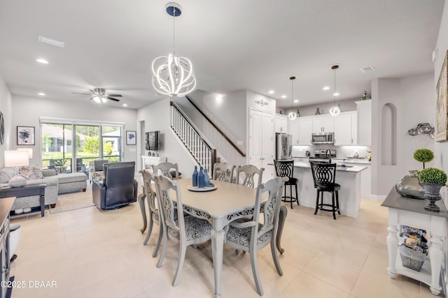 110 Longridge Ln, Ormond Beach, FL 32174 - dining area featuring ceiling fan, a chandelier, stairs, recessed lighting, and light tile patterned flooring