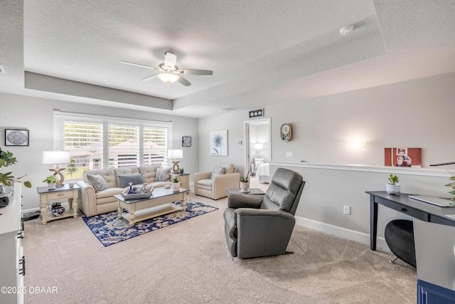 110 Longridge Ln, Ormond Beach, FL 32174 - carpeted living room featuring a tray ceiling, a ceiling fan, a textured ceiling, and baseboards