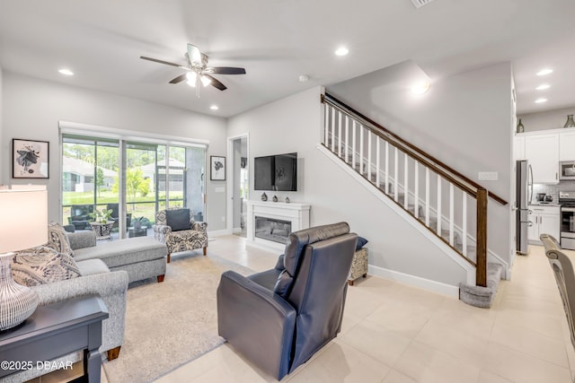 110 Longridge Ln, Ormond Beach, FL 32174 - living area featuring a ceiling fan, recessed lighting, a glass covered fireplace, stairway, and baseboards
