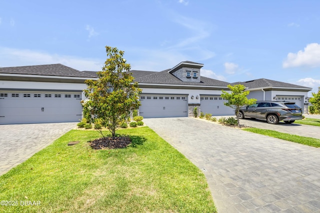 110 Longridge Ln, Ormond Beach, FL 32174 - prairie-style house with decorative driveway, a front lawn, a garage, and roof with shingles