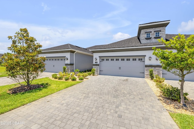 110 Longridge Ln, Ormond Beach, FL 32174 - prairie-style home featuring stucco siding, stone siding, decorative driveway, and a garage