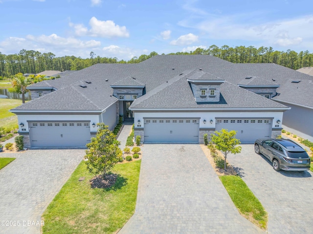 110 Longridge Ln, Ormond Beach, FL 32174 - view of front facade with decorative driveway, stucco siding, and stone siding