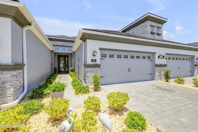 110 Longridge Ln, Ormond Beach, FL 32174 - view of front of home featuring stone siding, stucco siding, and decorative driveway