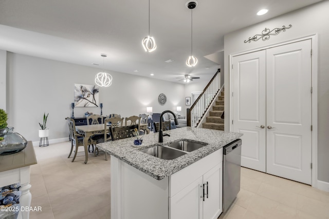 110 Longridge Ln, Ormond Beach, FL 32174 - kitchen featuring a sink, stainless steel dishwasher, decorative light fixtures, white cabinetry, and a center island with sink