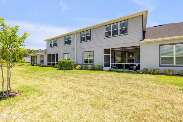 110 Longridge Ln, Ormond Beach, FL 32174 - rear view of house with a yard, roof with shingles, stucco siding, and a sunroom