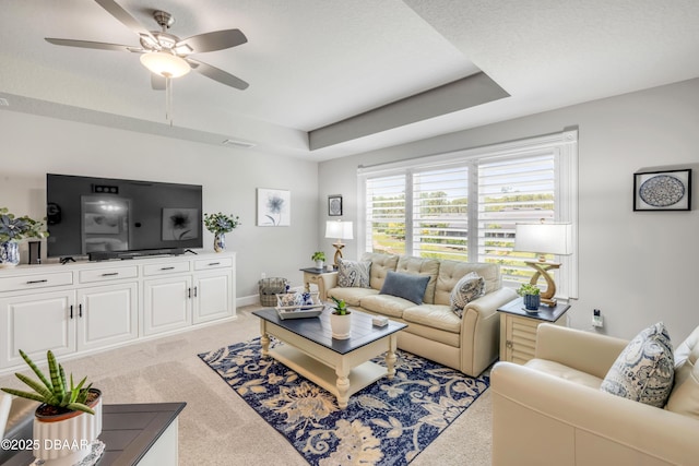 110 Longridge Ln, Ormond Beach, FL 32174 - living area featuring light colored carpet, a ceiling fan, and a raised ceiling