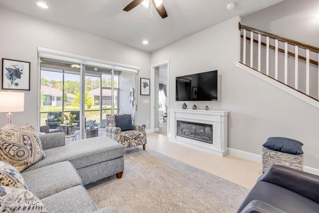 110 Longridge Ln, Ormond Beach, FL 32174 - tiled living room featuring ceiling fan, a glass covered fireplace, recessed lighting, baseboards, and stairway