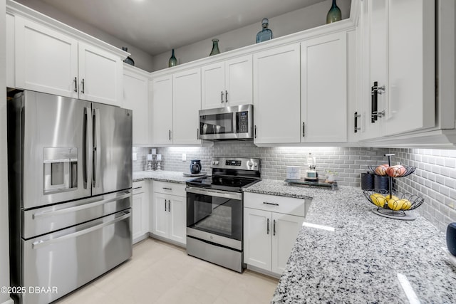 110 Longridge Ln, Ormond Beach, FL 32174 - kitchen featuring stainless steel appliances, white cabinets, light stone counters, and tasteful backsplash