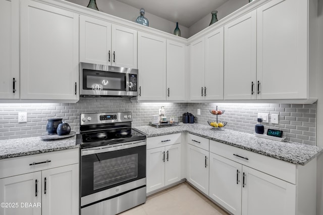 110 Longridge Ln, Ormond Beach, FL 32174 - kitchen with appliances with stainless steel finishes, white cabinets, and decorative backsplash