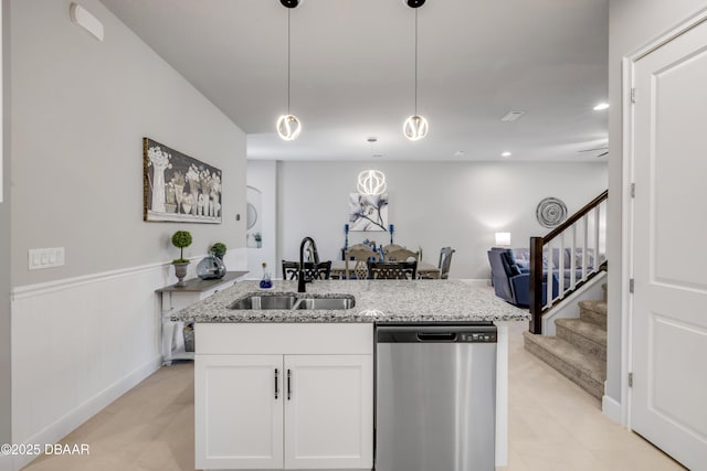 110 Longridge Ln, Ormond Beach, FL 32174 - kitchen with dishwasher, a sink, open floor plan, light stone counters, and white cabinets