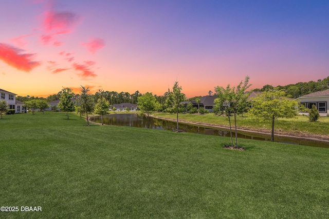 110 Longridge Ln, Ormond Beach, FL 32174 - yard at dusk with a water view and a lawn