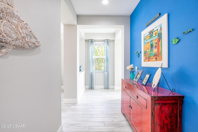 corridor with light hardwood / wood-style flooring