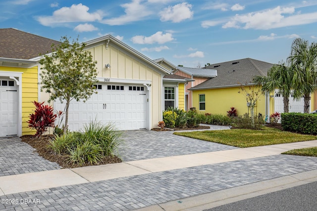 ranch-style house with a garage and a front yard