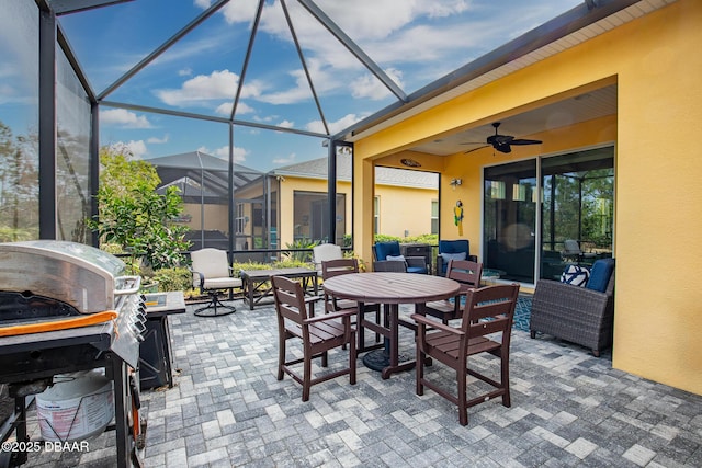 view of patio with a grill, ceiling fan, and glass enclosure