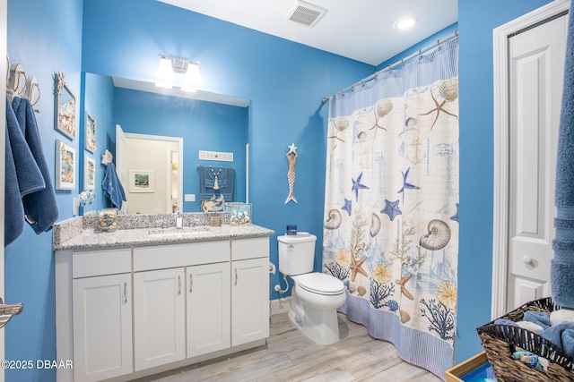 bathroom with hardwood / wood-style flooring, vanity, toilet, and a shower with shower curtain